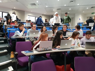 Students in simulation teams using laptops in lecture theatre