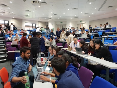 Lecture theatre with students using laptops in teams for simulation event