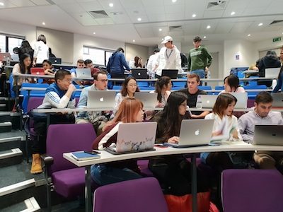 Students collaborating around a boardroom table
